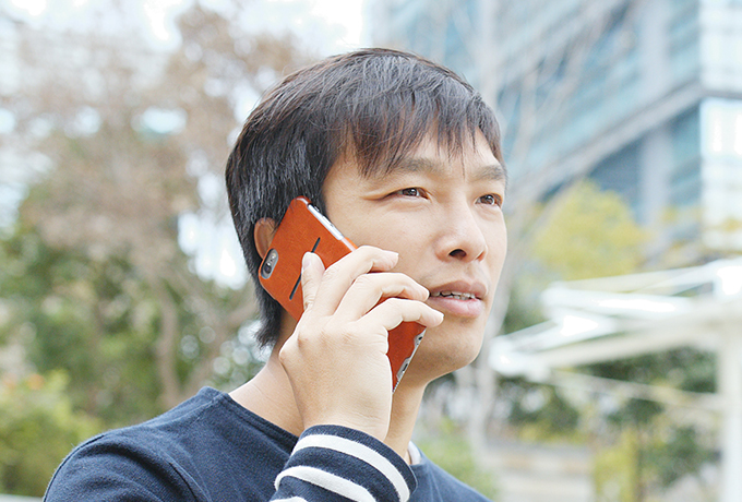 Man talking on a phone accessing phone and online counselling