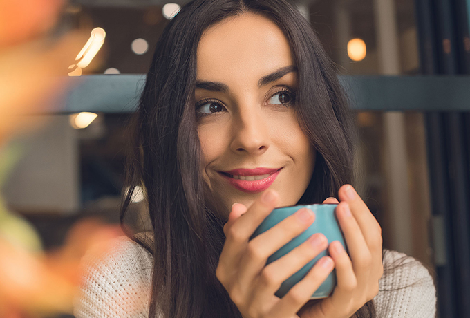 Image of a woman drinking coffee