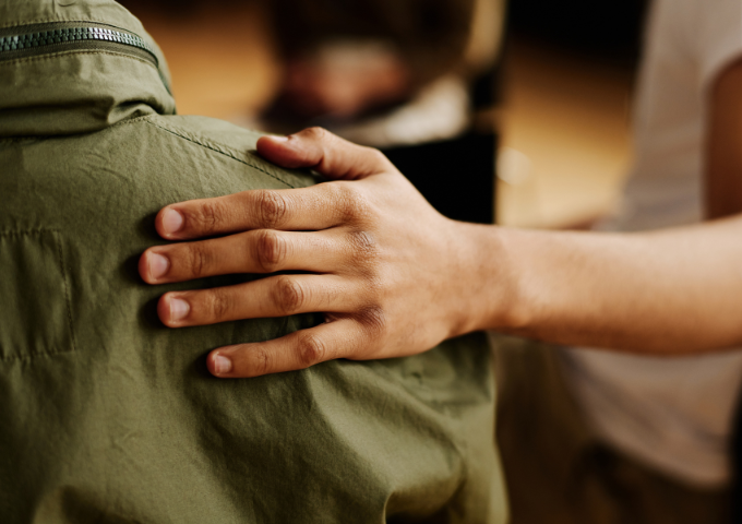 Someone with hand on shoulder