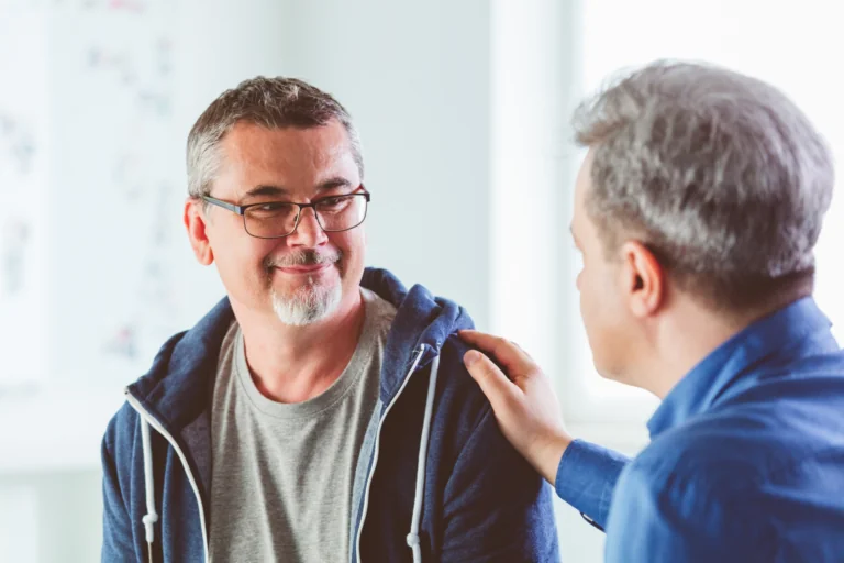 A man speaking with a friend