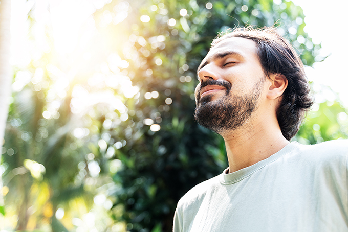 Man outside in nature meditating