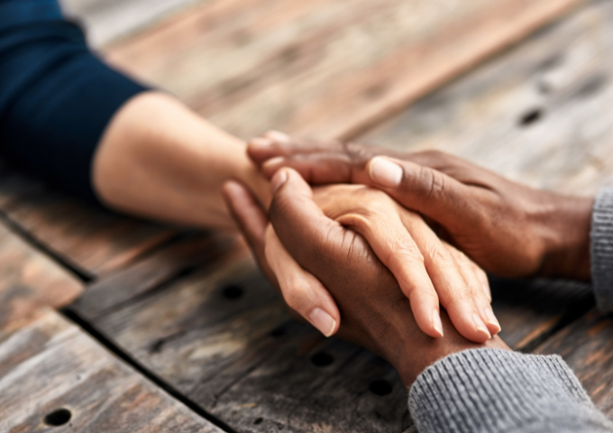 Two hands holding another persons hand