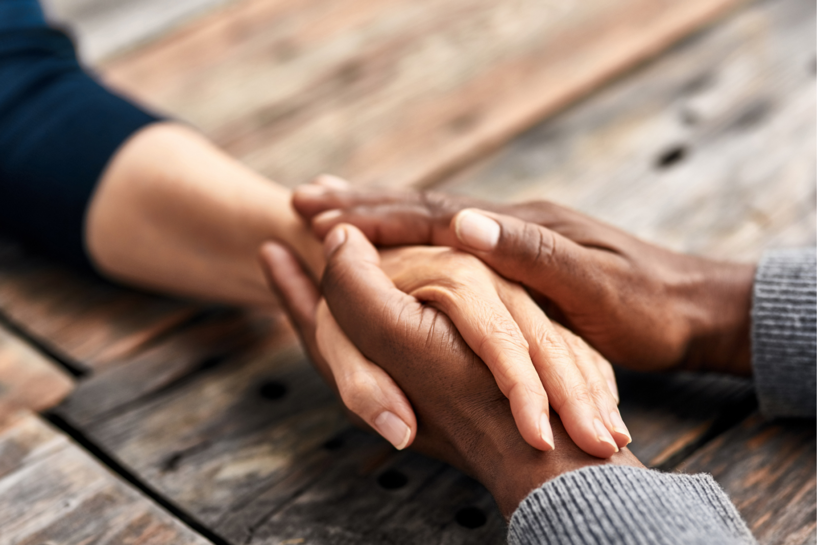Two hands holding another persons hand