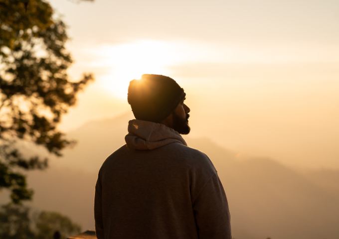 Man looking out at morning light