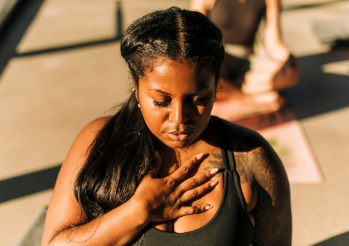 Woman with hand on chest